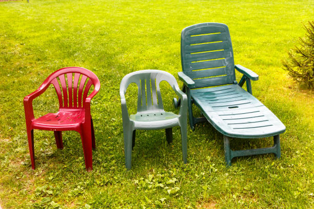 istock Wet plastic chairs stand on the green grass after the rain. 1273678989