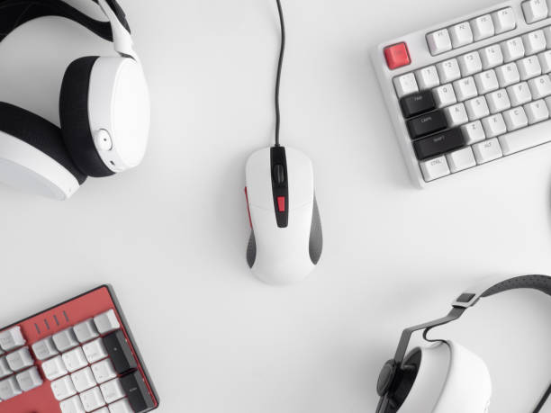istock gamer work space concept, top view a gaming gear, mouse, keyboard, joystick, headset, mobile joystick, in ear headphone and mouse pad on table background. 1273679856