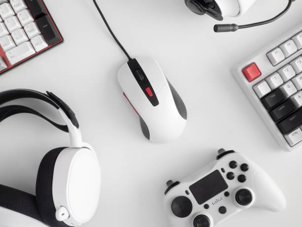 istock gamer work space concept, top view a gaming gear, mouse, keyboard, joystick, headset, mobile joystick, in ear headphone and mouse pad on table background. 1273679860
