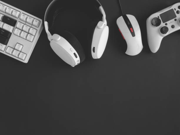 istock gamer work space concept, top view a gaming gear, mouse, keyboard, joystick, headset, mobile joystick, in ear headphone and mouse pad on black table background. 1273679870