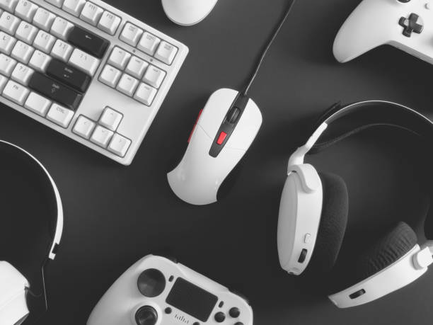 istock gamer work space concept, top view a gaming gear, mouse, keyboard, joystick, headset, mobile joystick, in ear headphone and mouse pad on black table background. 1273679871