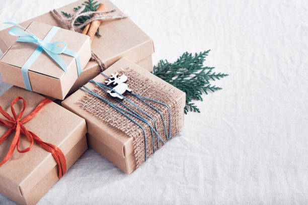 istock Christmas gifts on white crumpled fabric. Ecological packaging. Zero waste holidays. 1273683549