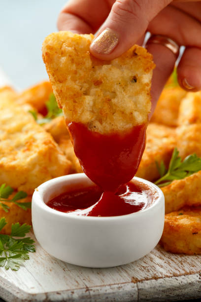 istock Hash brown potato with ketchup on white wooden board 1273683953