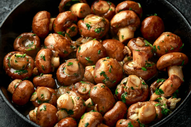 istock Fried mushrooms with onion and garlic in iron cast pan 1273683958