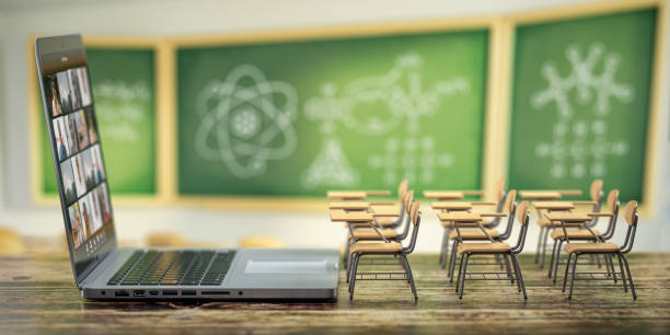 istock Online education and e-learning concept. Home quarantine distance learning. Laptop and school desks on blackdesk in classroom background. 1273685880