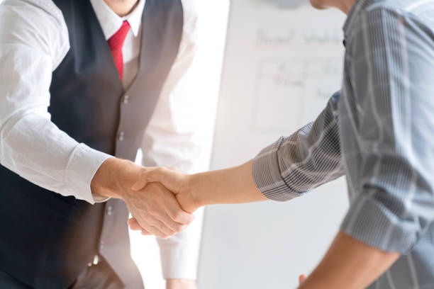 istock close up Businessman making handshake with partner - greeting, dealing, merger and acquisition concepts formal cloths 1273689048