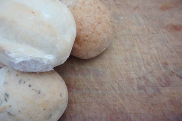 istock three flavored breads of different flours, saved, whole, on cutting wooden board 1273692182