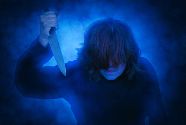 istock Frightening woman holding a knife 1273693213