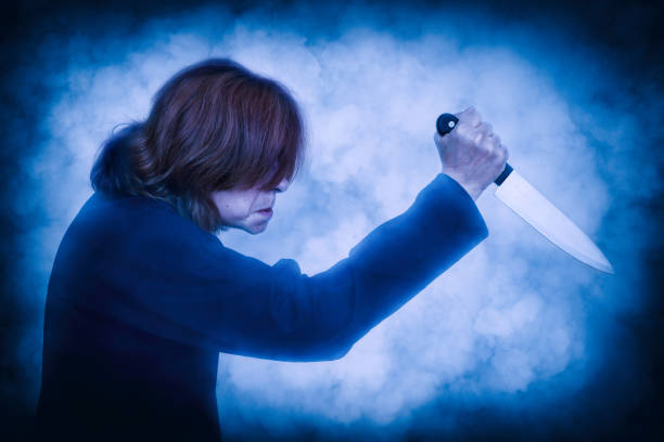 istock Frightening woman holding a knife 1273693381