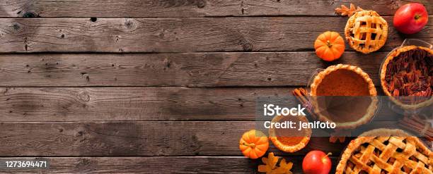 Assorted Homemade Autumn Pies Pumpkin Apple And Pecan Corner Border On A Rustic Wood Banner Background Stock Photo - Download Image Now