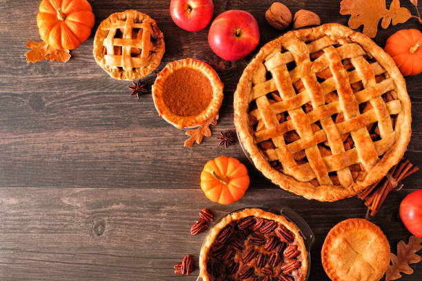 istock Assorted homemade autumn pies. Corner border on a rustic wood background. 1273694479