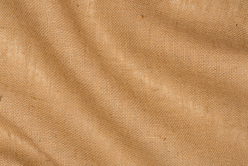 Burlap texture background. Linen burlap drapery close up.