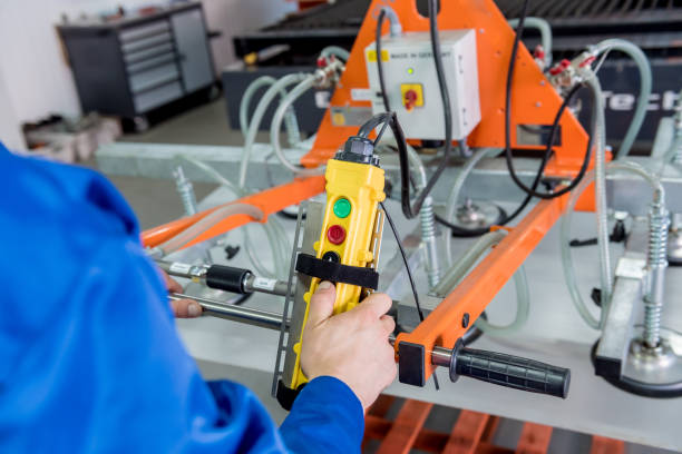 istock Worker uses suction cups for transporting large sheets of metal 1273695176