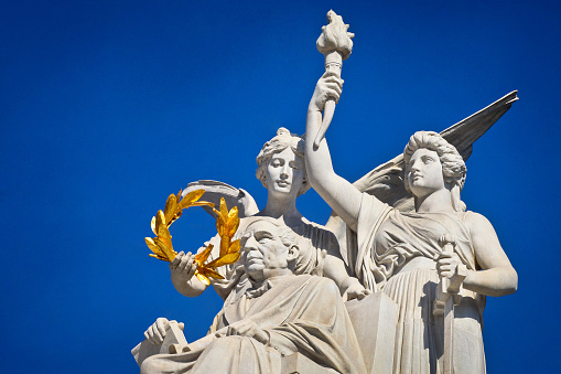 Statue of Saint Peter and the big Golden Key of heaven in Valtican view from below and blue sky