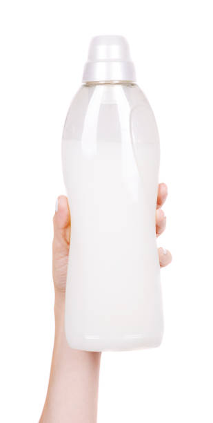 istock Hand with laundry detergent in bottle, isolated on white background. 1273700168