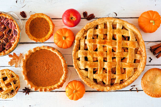 istock Assorted homemade autumn pies. Table scene on a white wood background. 1273700336