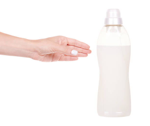 istock Hand with laundry detergent in bottle, isolated on white background. 1273701303