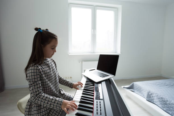 istock little girl studying with laptop online learning 1273701338