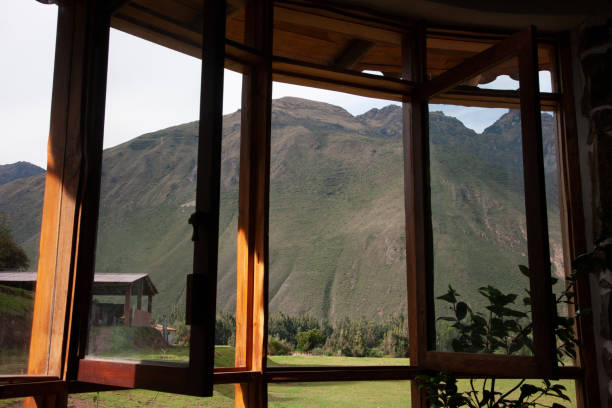 istock Large glass windows that are opened and have a beautiful view on a large with grass covered mountain 1273708045