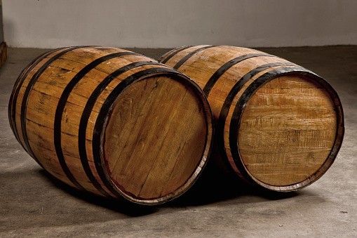 Two wooden barrels for storage and aging of alcoholic beverages.