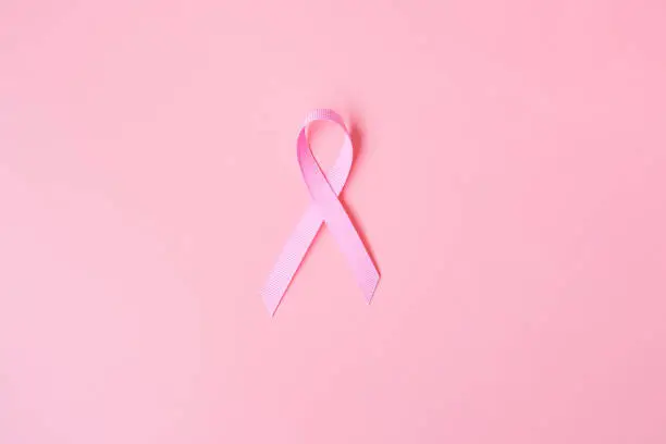 Photo of October Breast Cancer Awareness month, Pink Ribbon on pink background for supporting people living and illness. International Women, Mother and World cancer day concept