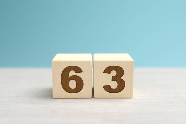 istock Wooden toy blocks forming the number 63. 1273709590