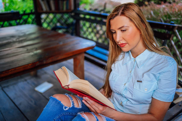 istock Woman reading a book outdoor 1273716114