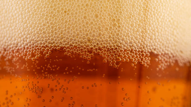 beer foam in a glass, macro photography, beer foam in a glass, macro photography, soft focus craft beer stock pictures, royalty-free photos & images