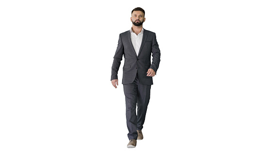Wide shot. Front view. Serious businessman with a beard and in formal suit walking on white background. Professional shot in 4K resolution. 044. You can use it e.g. in your medical, commercial video, business, presentation, broadcast