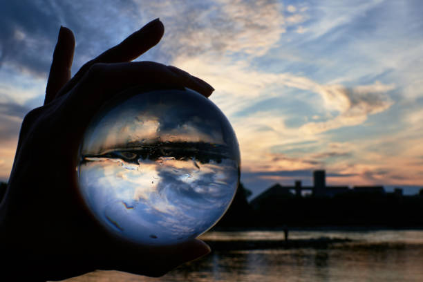 istock Looking through a lensball in front of the beautiful sunset sky 1273721849