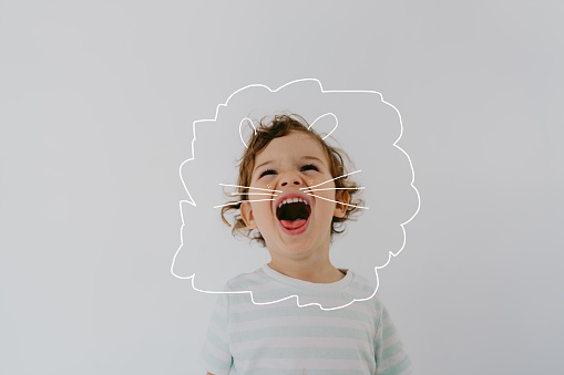 Photo of a two year old boy, with a doodle art showing his true nature; baby lion.