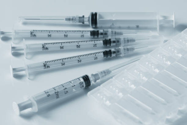 istock plastic syringes and plastic capsules with medicine are on a white table 1273725332