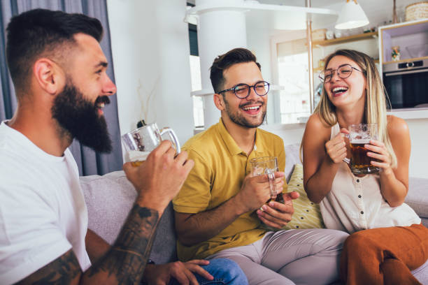 istock Happy friends drinking beer enjoying time together. 1273730939