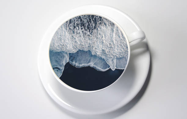 Sea in the cup. White cup with water. Sea waves. Creative postcard.