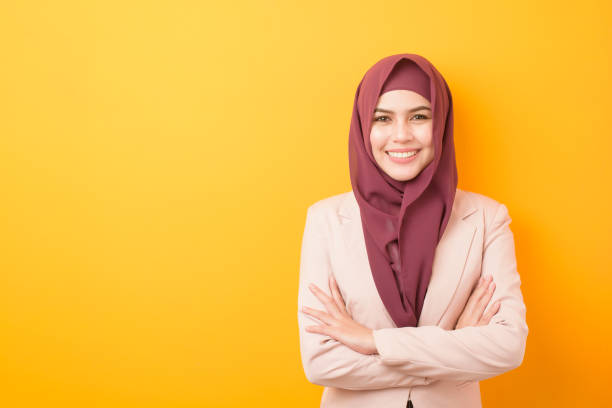 Beautiful business woman with hijab portrait on yellow background Beautiful business woman with hijab portrait on yellow background arabic girl stock pictures, royalty-free photos & images