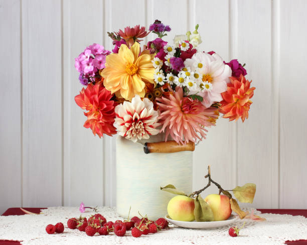 istock dahlias in a can, apples and raspberries on the table. rustic interior. 1273735782