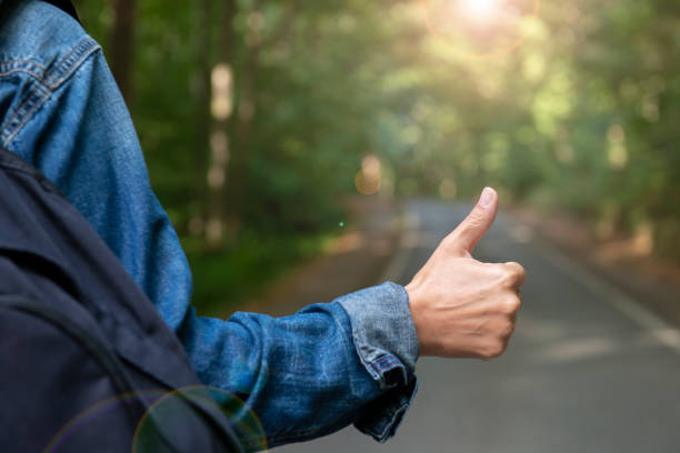 istock Young Woman Hitchhiking 1273737446