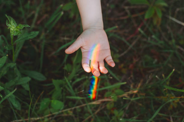 Close up of kids hand with rainbow
