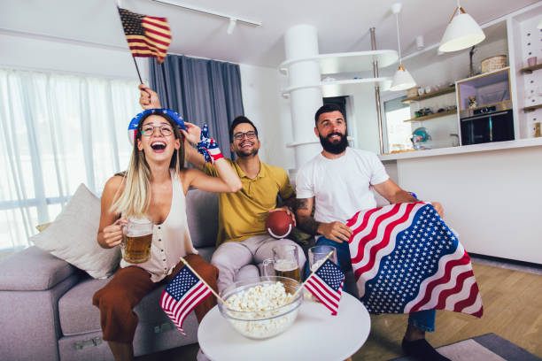 istock Young Friends Cheering While Watching Rugby Match At Home 1273740009