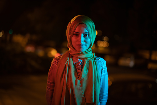 Young muslim girl with hijab posing for a portrait outdoor ay night