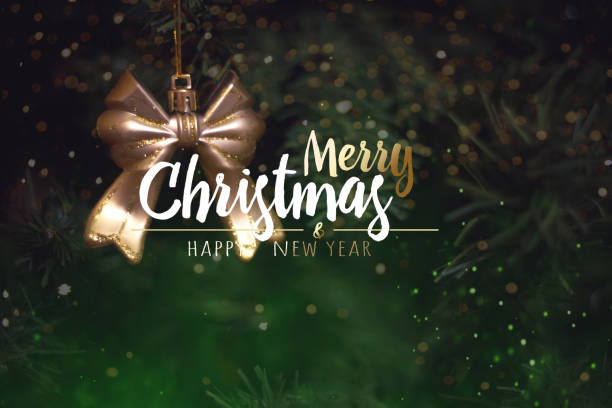 istock Christmas tree background and Christmas decorations with blurred, sparking, glowing and text Merry Christmas and Happy New Year. 1273747583