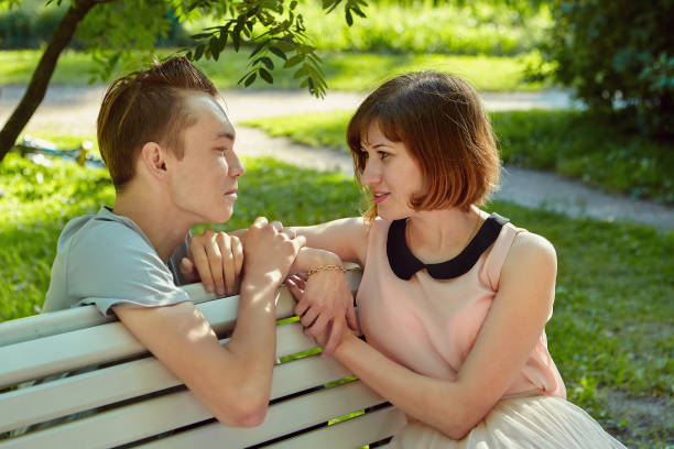 istock Young couple has meeting in public park. 1273747621