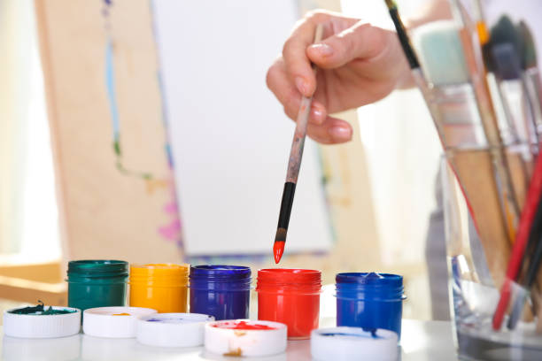 istock the artist's hand holds a brush 1273749045