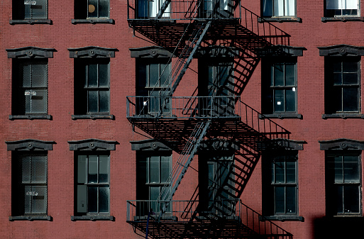 Old building with fire escape facade in downtown Manhattan, New York City.