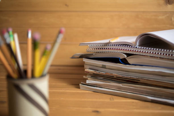 istock Stack of school books and pencil holder on desk 1273750016