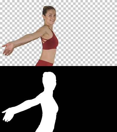 On Alpha Matte. Medium shot. Side view. Sportive fitness sportswoman stretching arms and laughing, Alpha Channel Professional shot in 4K resolution. 009. You can use it e.g. in your sport, yoga, healthy, commercial video, business, presentation, broadcast