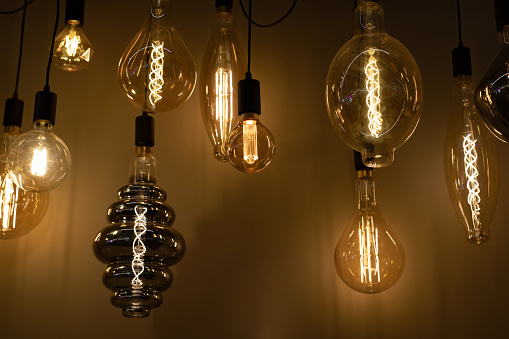 Vintage lamps with intricate filament, a set of large lamps of different shapes, background backdrop lighting for design