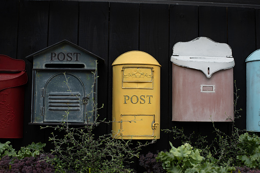 Vintage mailbox. Beautiful old-fashioned mailboxes black yellow red. Shabby weathered postbox set, background backdrop