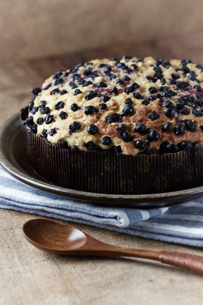Simple Cake with Bilberries on wooden background.