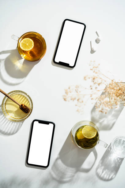 istock Smart phone mockup, template on table with cup of herbal tea 1273759399